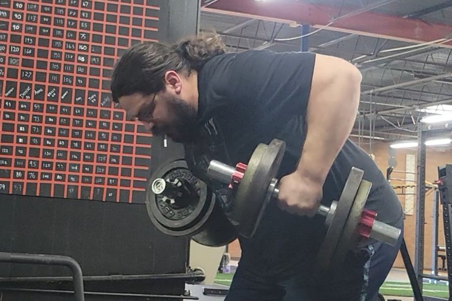 Man performing bent-over rows with the Titan Loadable Dumbbells