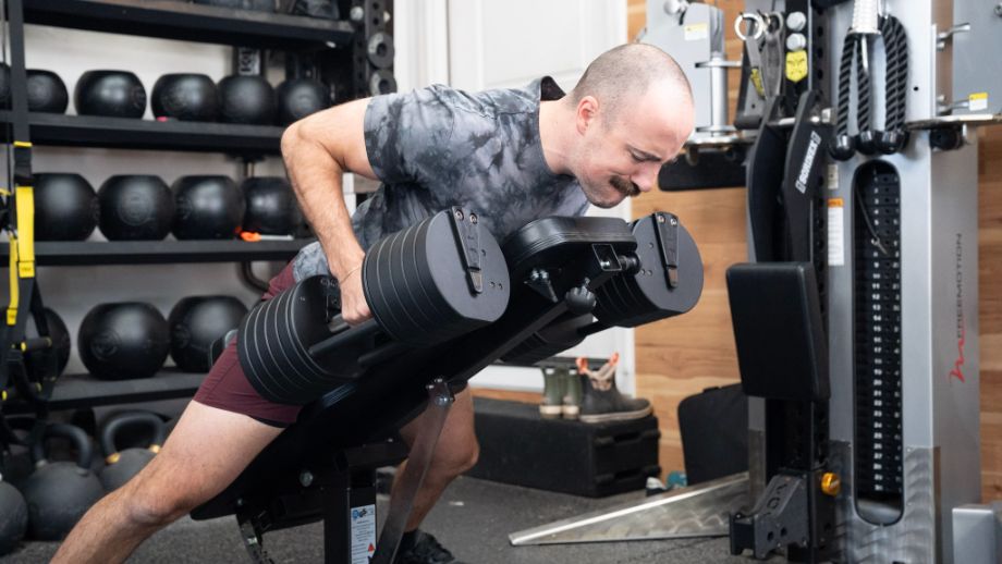 Man performing chest-supported rows with the REP QuickDraw adjustable dumbbells