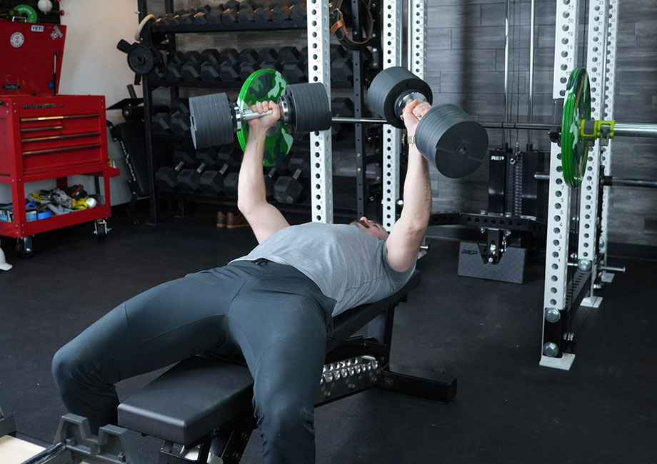 Coop doing bench press with the Snode AD80 dumbbells