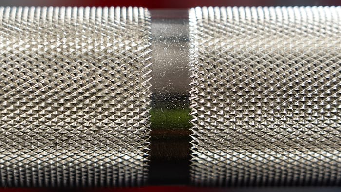 Close-up image of the knurling on an Olympic barbell