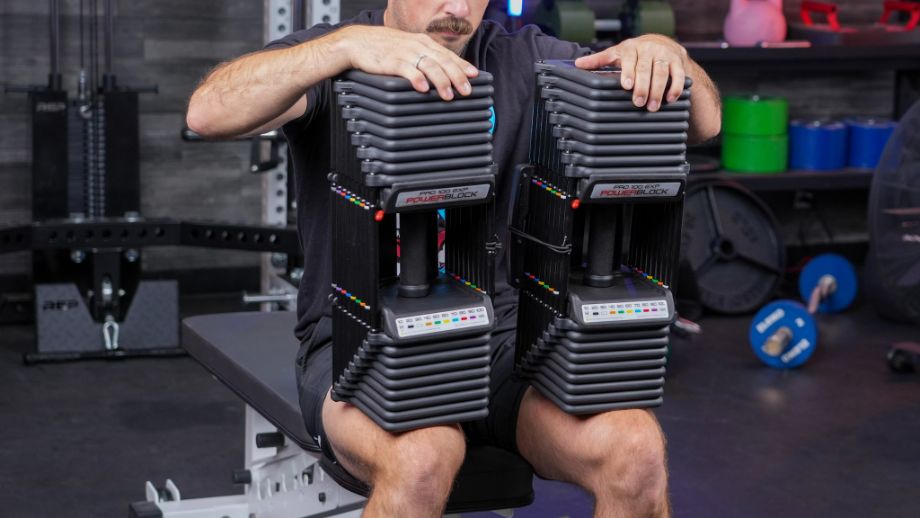 Man holding the PowerBlock Pro 100 EXP Dumbbells