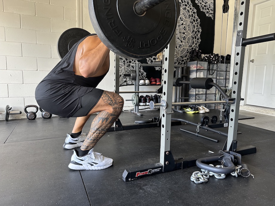 A man squatting in the Reebok Nano Gym Shoes