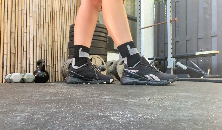 A person wearing the Reebok Nanoflex TR shoes