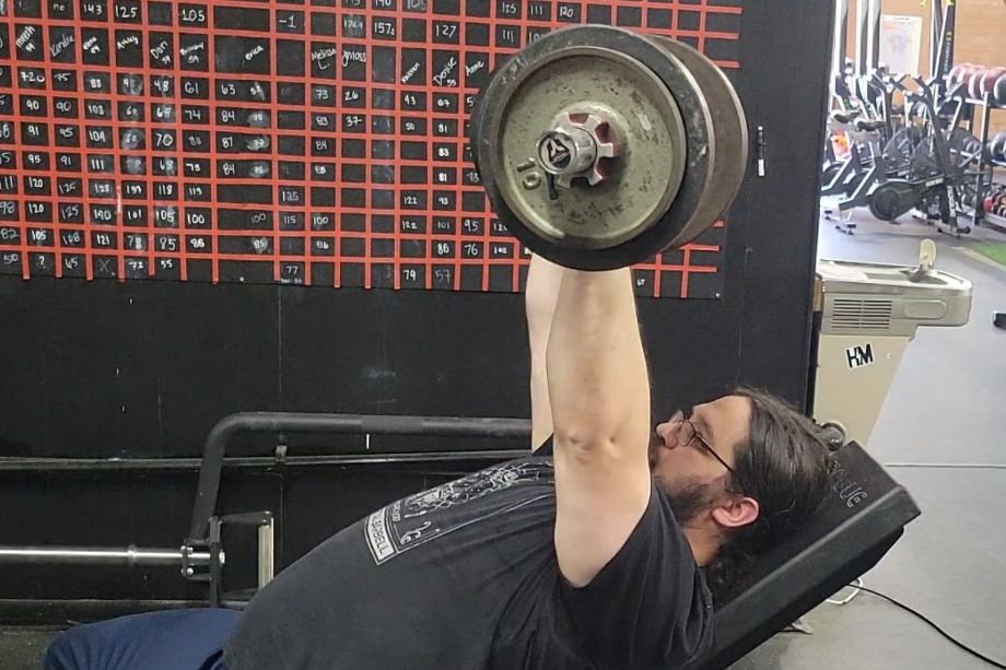 Man performing an incline press for the Titan Loadable Olympic Dumbbell Handles Review cover image